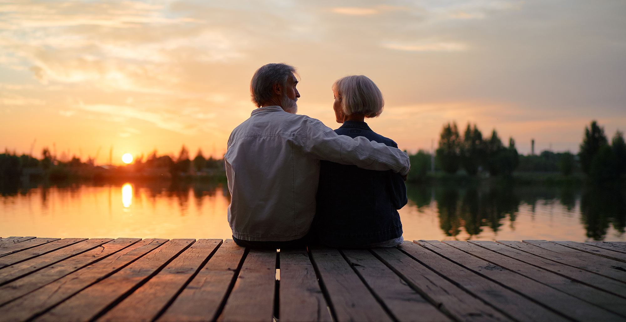 Mature couple sitting by a lake